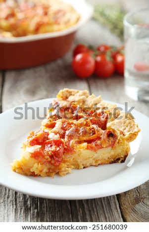 Fresh tomato pie on grey wooden background