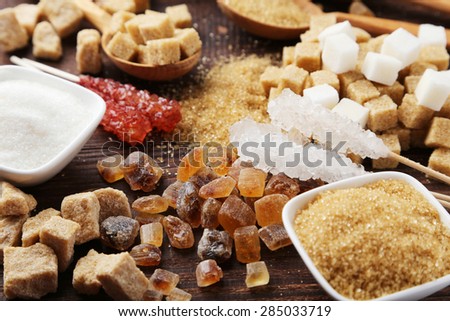 Various kinds of sugar on brown wooden background