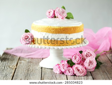 Sweet cake on cake stand on grey wooden background