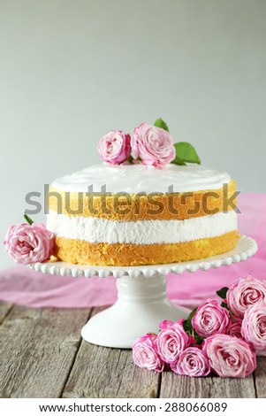 Sweet cake on cake stand on grey wooden background