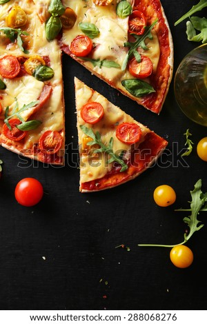 Fresh tasty pizza on black background