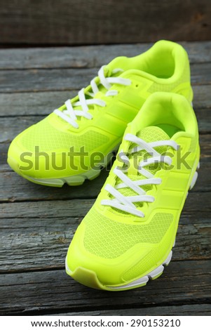 Pair of sport shoes on blue wooden background