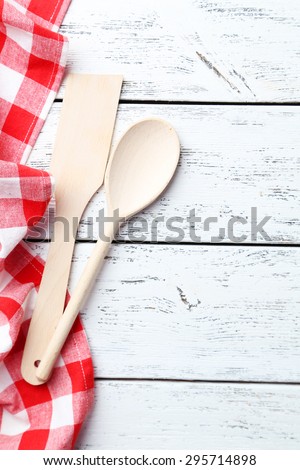 Empty wooden table with wooden spoon and napkin on white background