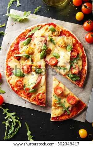 Fresh tasty pizza on black background