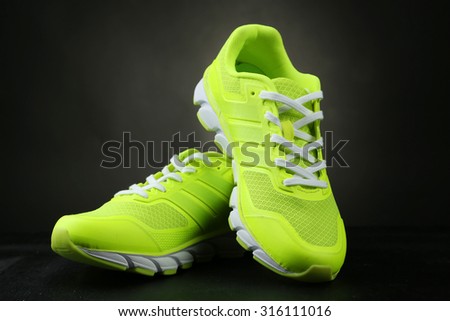 Pair of sport shoes on black background