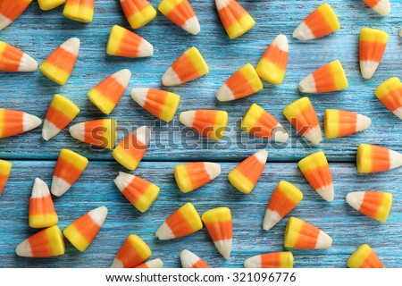 Halloween candy corns on blue wooden background