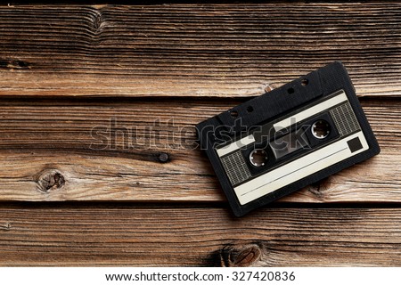 Audio tape cassette on brown wooden background