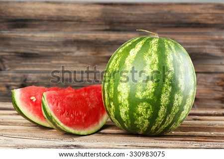 Tasty watermelon on brown wooden background