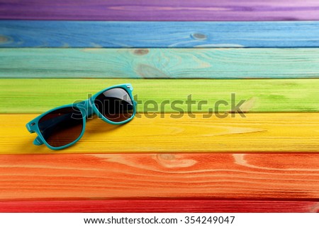 Sunglasses on a colorful wooden table