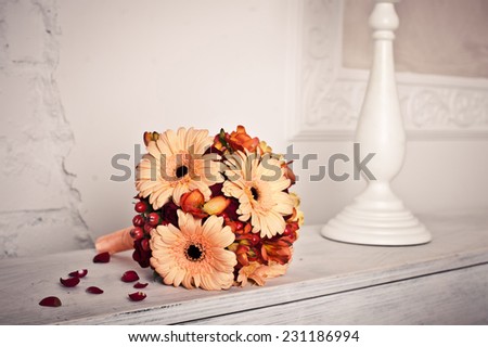 Bouquet on the piano. Beautiful it are yellow - a red bouquet on the piano.