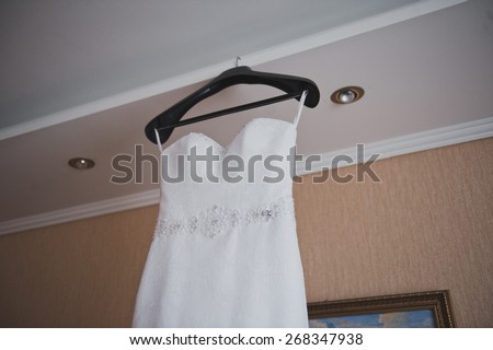 Wedding dress on a hanger.