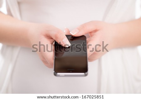 Close-up of female hands using touch screen mobile smart phone