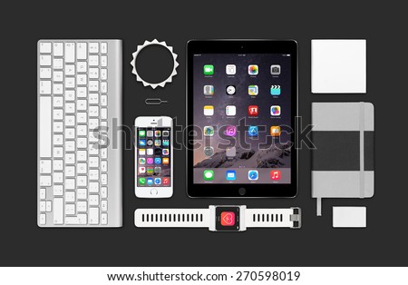 Varna, Bulgaria - February 09, 2015: Top view of Apple products mockup. Consists of ipad air 2, iphone 5s, keyboard, smartwatch concept, notebook, eraser, bracelet, reminder.