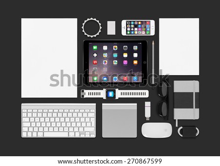 Varna, Bulgaria - February 10, 2015: Top view of Apple products mockup. Consists of ipad air 2, iphone 5s, keyboard, smartwatch concept, notebook, eraser, bracelet, reminder.