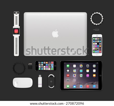 Varna, Bulgaria - February 11, 2015: Top view of Apple products tech mockup that includes retina macbook pro, ipad air 2, smart watch concept, iphone 5s, magic mouse, flash drive, bracelets.