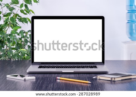 Laptop computer mockup with blank screen on office wooden desk. For design presentation or portfolio. All gadgets in full focus.