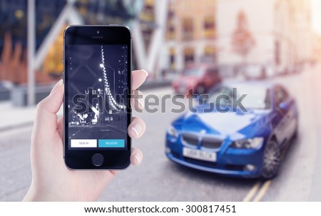 Uber application startup page on the Apple iPhone 5s display in female hand. Blurred street view with car and flare sun light on the background. Varna, Bulgaria - May 25, 2015.