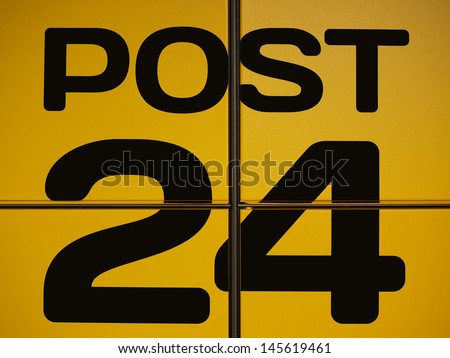 Black post office sign on the yellow background