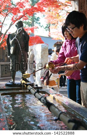 TOKYO,JAPAN - NOV 23: People washing the hand before entering to the temple at Mt.Takao in Kanto area nearby Tokyo ,Japan on November, 23, 2011