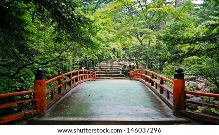 Red Bridge in the maple forest at Miyajima island in Hiroshima, Japan