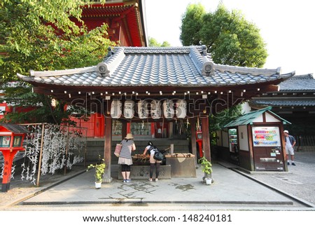 KYOTO, JAPAN - AUGUST 18:People is visiting and washing hands and mouth at the holy well in front of Yasaka shrine in Kyoto, Japan on August, 18th.