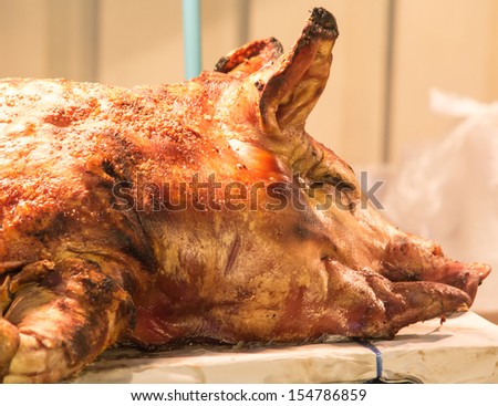 Golden head roasted pig in market