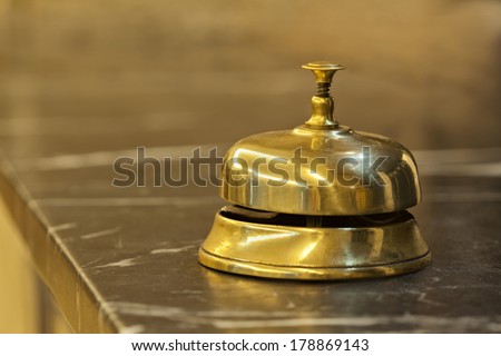 old hotel bell on a marble stand