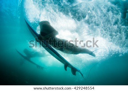 the girl dives under a wave. duck dive