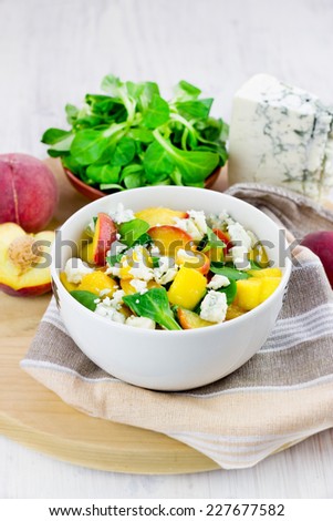 Green salad with grilled peaches, gorgonzola cheese and corn salad leaves, selective focus