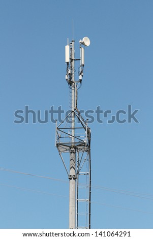 reinforced concrete pillar on which four antennas for mobile communication against the blue sky's