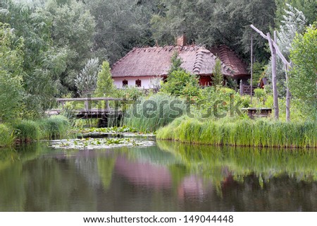 Ancient house on the lake in the Ukrainian village