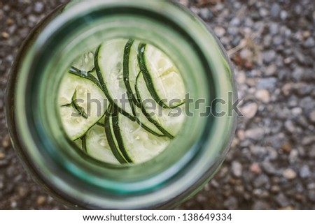 Unique angle looking down into a carafe of fresh organic cucumber water
