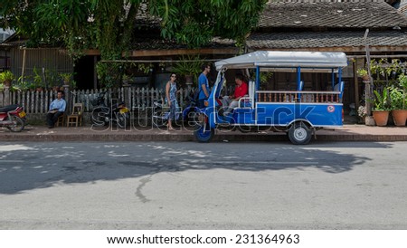 LUANG PRABANG, LAOS - MAY 12: Tuk-Tuk or mini van is  available all over town and easy way to get around. Mini van and mini bus can be hired through guesthouses and hotels on May 12, 2014 in Laos.
