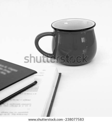 cup of coffee and two books on white background