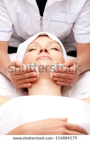 Woman Is Having Cosmetic Treatment At Spa Salon. Cosmetologist Medical Gloves Is Touching Girl\'S Face.