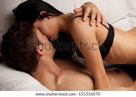 young lovers kissing on the couch