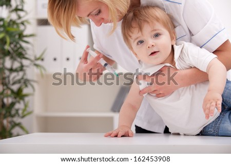 Doctor giving a child a huge injection in arm