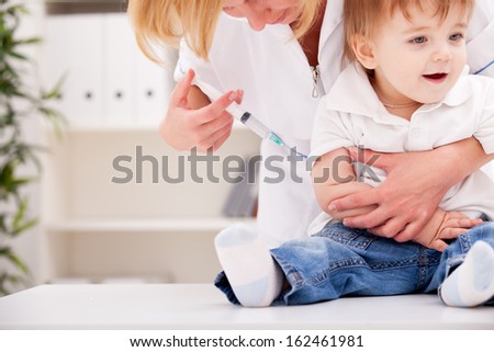Doctor giving a child a huge injection in arm