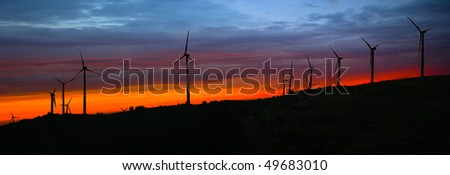 Silhouettes of wind turbines at sunset - the colors manipulated