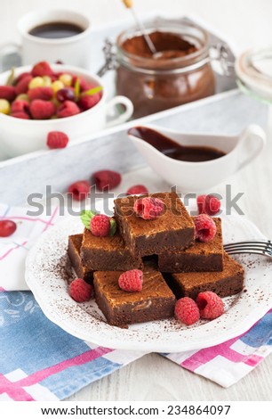 Homemade chocolate brownies decorated with fresh raspberry