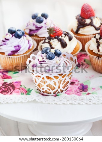 Set of delicious blueberry and strawberry cupcakes