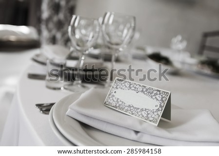 wedding table on which lies wedding card. glasses to blur pictures in BW