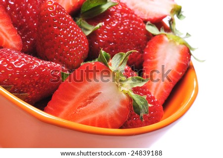 Close up of a group of fresh, succulent strawberries in orange cup