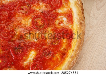 Pizza margarita on a wooden background