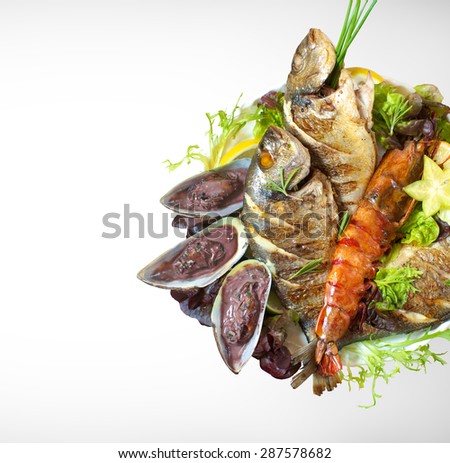 Sea food grilled fish mussels oyster shrimp whit salad vegetable on a white plate