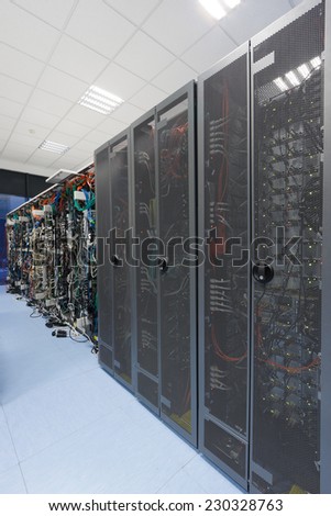 Different servers and disk arrays arranged in racks in the computer room