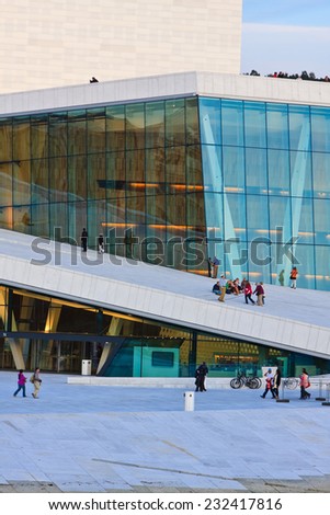 OSLO, NORWAY - AUGUST 12 2011: People are walking around and on the Oslo opera house roof in the summer evening after the sunset, Norway