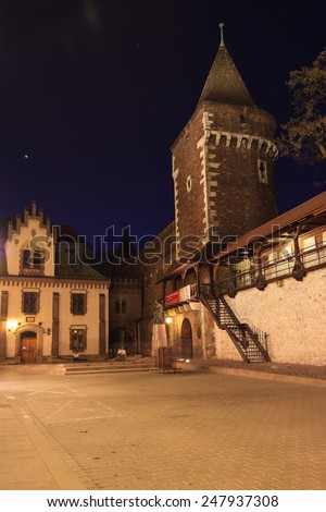 Krakow, Poland - April 28 2012: Watch tower on the city walls near Florian gate in Krakow at night. People resting on the stairs.