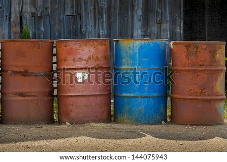 Four barrel of fuel or chemicals. One is blue.