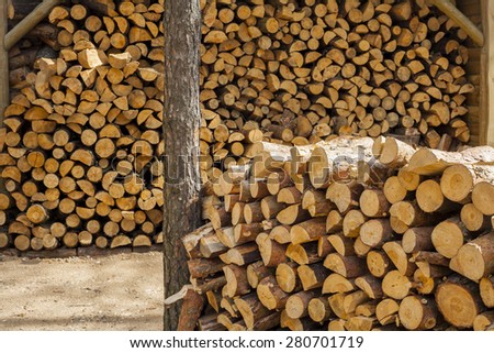 Accumulated felling the tree trunks. Wood for fuel and for fireplaces.
